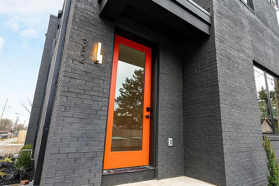 brand new modern development airbnb bright-orange door