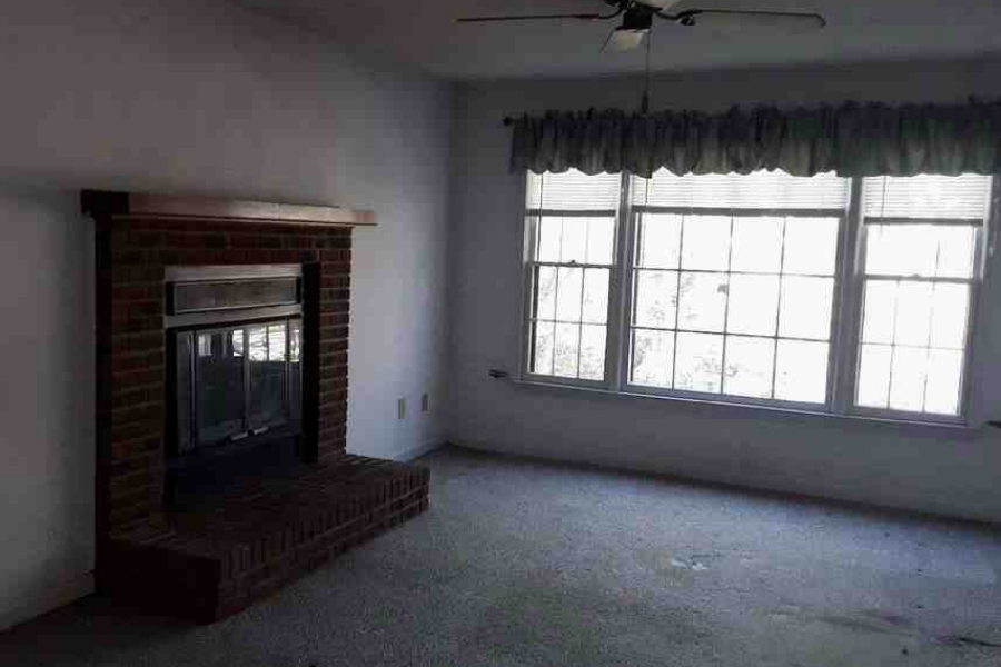 Living room fireplace before Raleigh fix and flip rehab